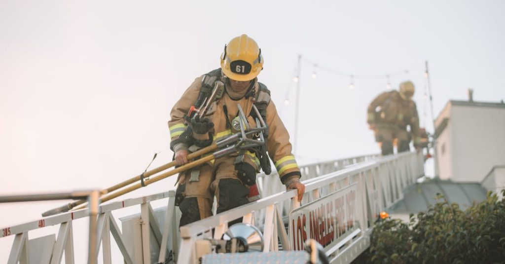 Firefighters in protective gear climbing down a ladder during a rescue operation. Teamwork in action.